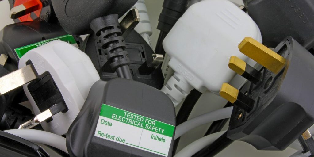 PAT testing device checking an electrical plug